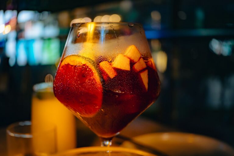 Close-up of a chilled glass of sangria with fresh fruit slices, creating a vibrant and refreshing feel.